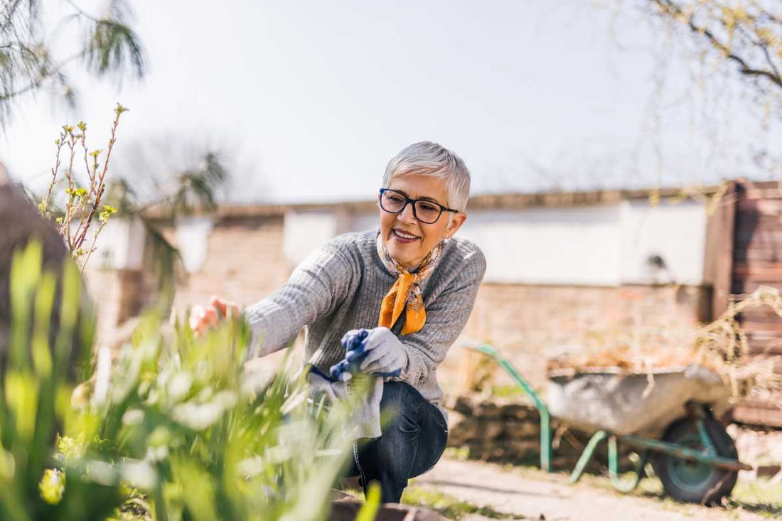Is gardening good for retirement? Here's an older woman enjoying planting and tending to her garden outdoors